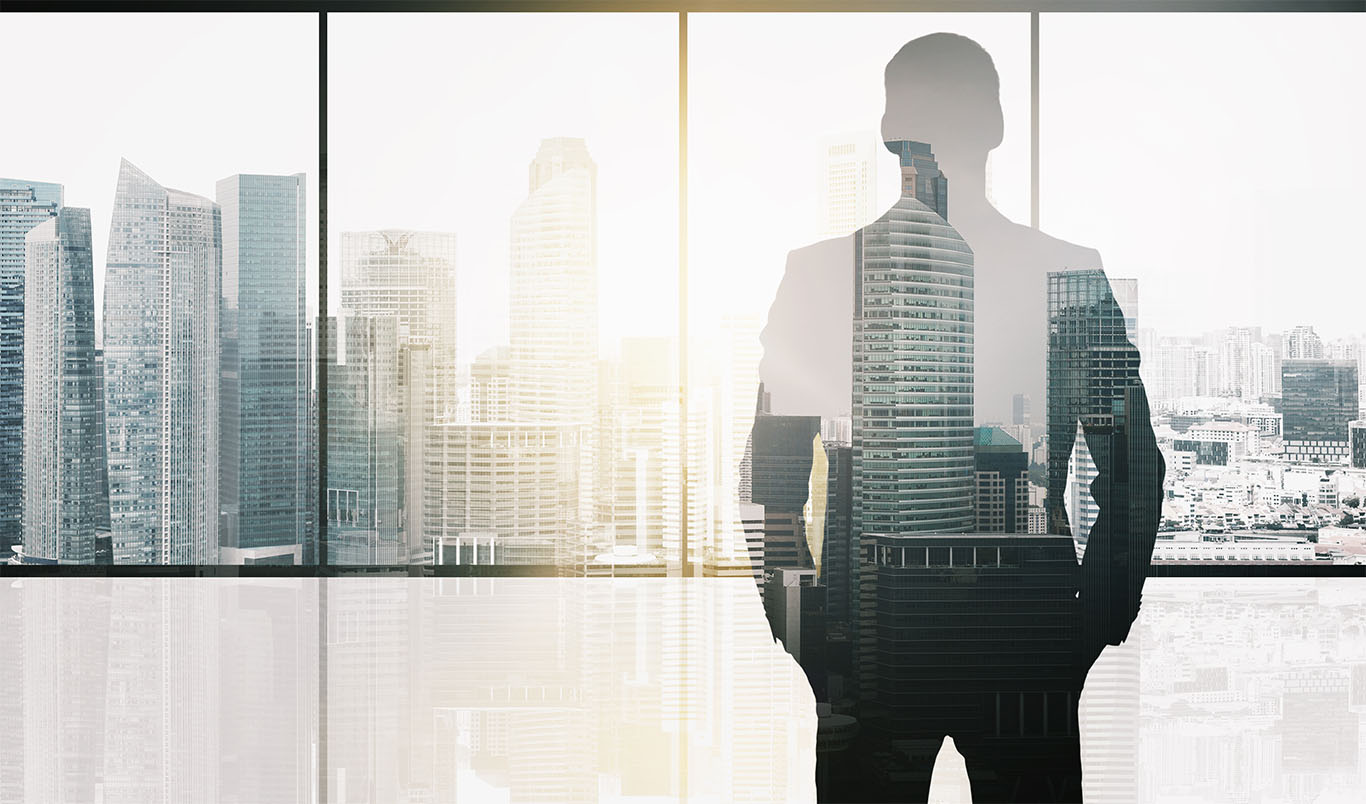 Image of a males silhouette in a skyscraper office building to support CEO daily routine article