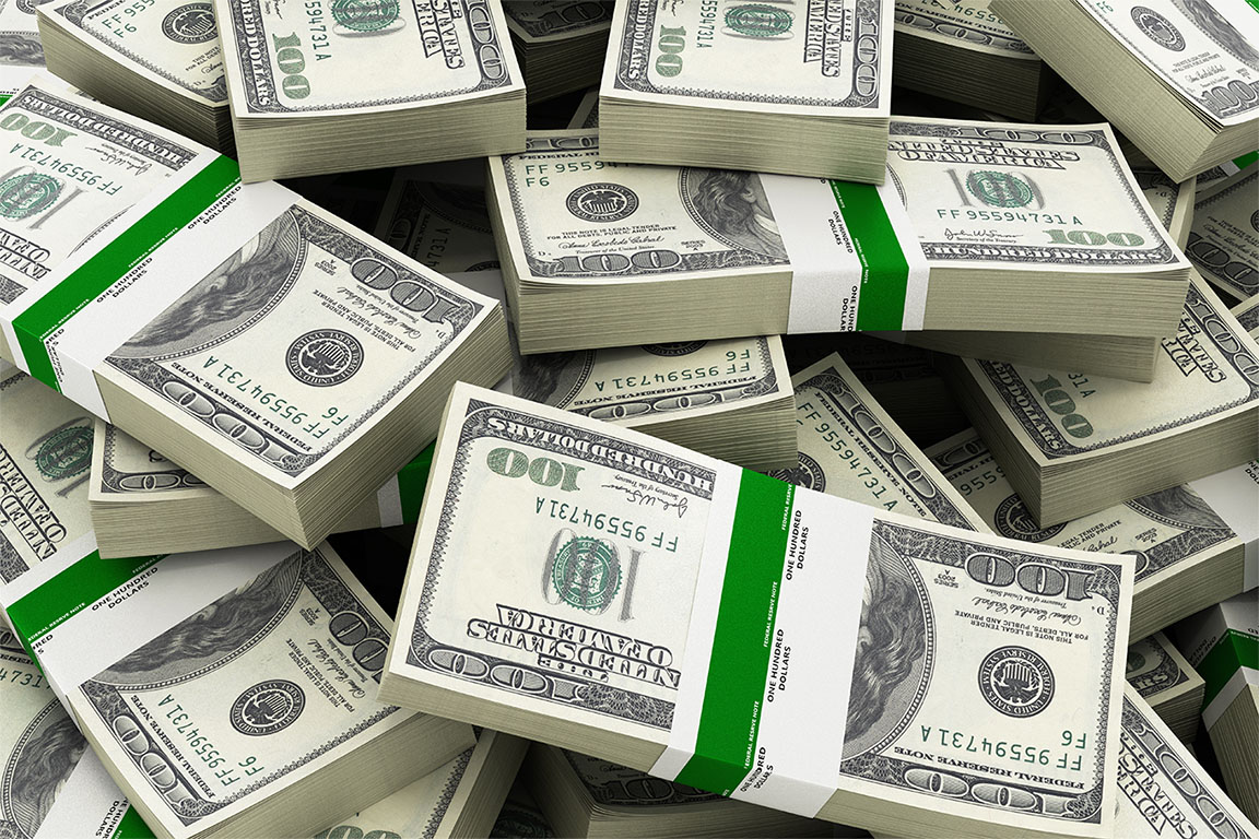 Image of numerous stacks of American dollars piled on top of each other to support 6 figure side hustle article