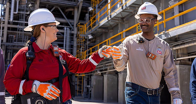 2 workers bump fists at P66 refinery