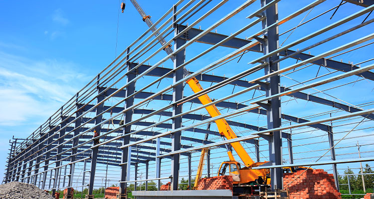 Asset reliability and operational readiness are key to the success of any new capital project Steel framed building under construction
