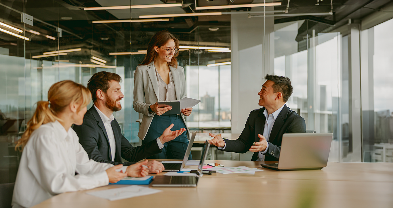 emotionally intelligent leadership in business setting with colleagues smiling at each other