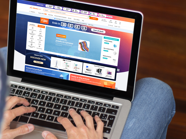 Man browsing the Alibaba website on laptop